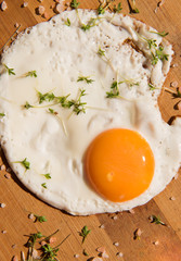 
fried egg with red paprika and Himalayan salt on a bamboo board