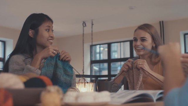 Young knitting women in the loft