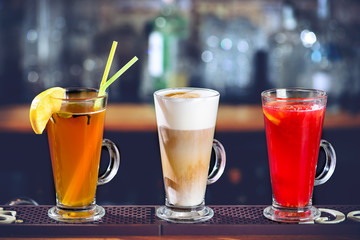 Three different alcoholic cocktails at the bar counter