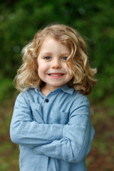 Happy child with long blond hair enjoying the nature