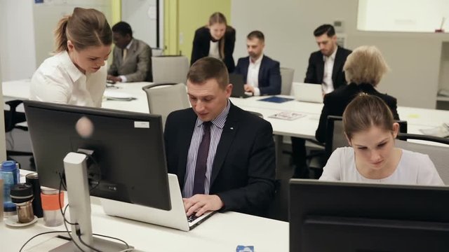 Group of successful business people during daily work in modern co-working space