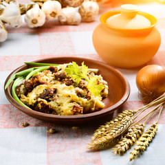 Traditional Belarusian and Ukrainian Cuisine. Potato babka, baked cake made of potato, meat and onion on the plate in rays of the sun. Top view, flat lay