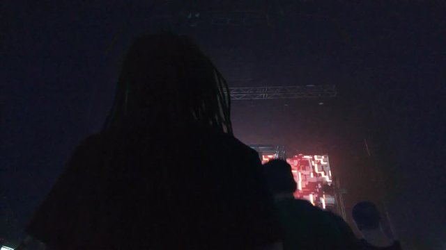 Silhouette of a dancing man with dreadlocks. Drum and bass dance, stepping