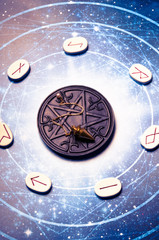 runes symbols on white stones, magic pentagram with esoteric pendulum and astrology background 