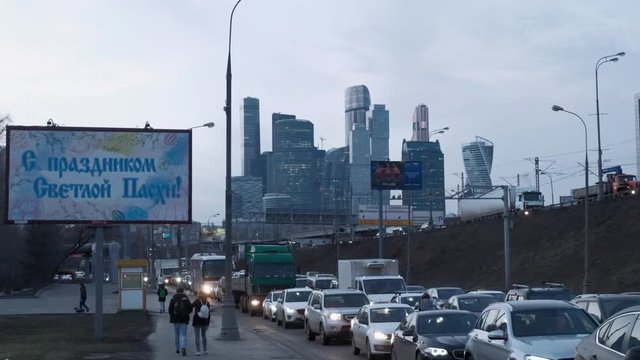 Traffic Jam Against The Background Of A Billboard And Skyscrapers Moscow City.