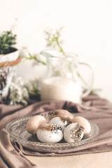 Beautiful pastel eggs with feathers on a glass plate and  milk in a glass