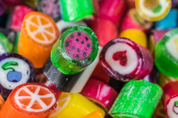 Colorful candy sweets close up, selective focus. Different tastes and drawings of fruits on candies, watermelon taste in front, made in prague