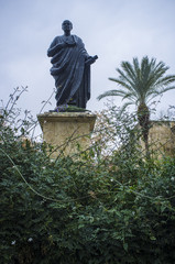 Bronze Statue of Seneca the Younger between jasmine garden
