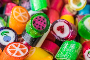 Colorful candy sweets close up, selective focus. Different tastes and drawings of fruits on candies, watermelon taste in front, made in prague