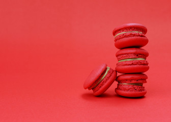 Red color tone for French mini macaroons cookie stack on red backgrounds