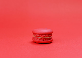 Single red macaroons cookie on red backgrounds
