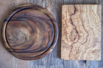 Chopping boards of different shapes on a wooden background. View from above.