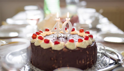 Fototapeta na wymiar Happy 40th birthday cake on table