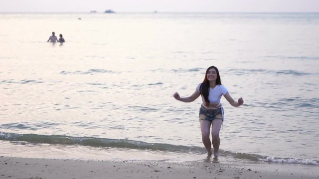 slow motion of woman jumping on the sea beach