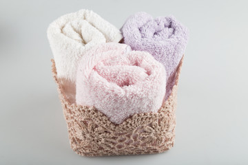 Towel concept. Spa concept. Photo for hotels and massage parlors. Purity and softness. Towel textile. pink,grey towels. bathroom concept.