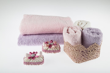 Fototapeta na wymiar Towel concept. Spa concept. Photo for hotels and massage parlors. Purity and softness. Towel textile. pink,grey towels. bathroom concept.
