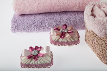Obraz na płótnie Canvas Towel concept. Spa concept. Photo for hotels and massage parlors. Purity and softness. Towel textile. pink,grey towels. bathroom concept.