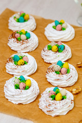 Mini Pavlova meringue nest with eggs, easter sweets