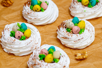 Mini Pavlova meringue nest with eggs, easter sweets