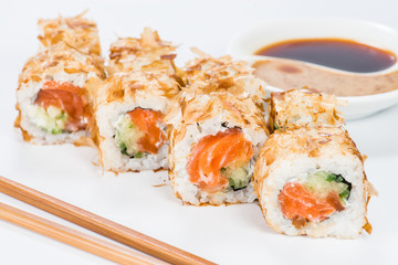 Traditional Japanese cuisine. Tasty sushi rolls with rice, cream cheese, salmon and tuna on light background