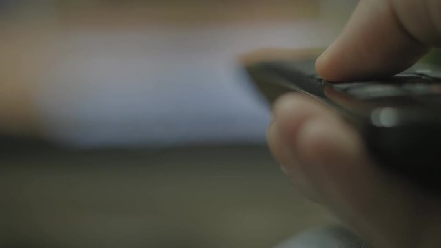 Hand using tv remote controller