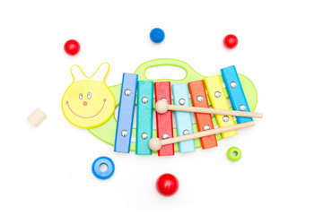 Wooden, bright toy xylophone on a white background. Educational toys