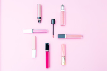 Cosmetics set for makeup on a pink background. Geometric style