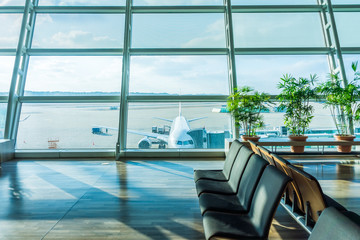 Waiting area of concourse in airport. Near parking position of an airplane.
