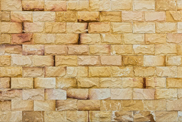 Natural yellow rock fence. The exterior decoration of many building.