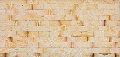 Natural yellow rock wall. The exterior decoration of many building.