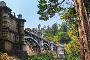 Arched stone bridge for transport and pedestrians in the rainforest near the Royal Botanical Garden in Kandy, Sri Lanka