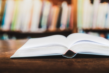 Education learning concept with opening book or textbook in old library, Book in library with old open textbook, Stack piles of literature text academic archive on reading desk in school class room