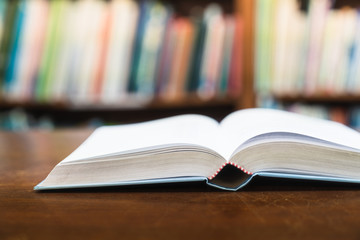Education learning concept with opening book or textbook in old library, Book in library with old open textbook, Stack piles of literature text academic archive on reading desk in school class room