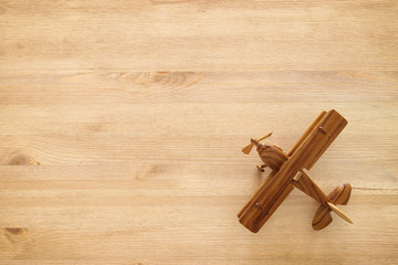 top view photo of toy airplane over wooden background.