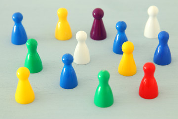 image of colorful game figures over wooden table ,human resources and management concept.