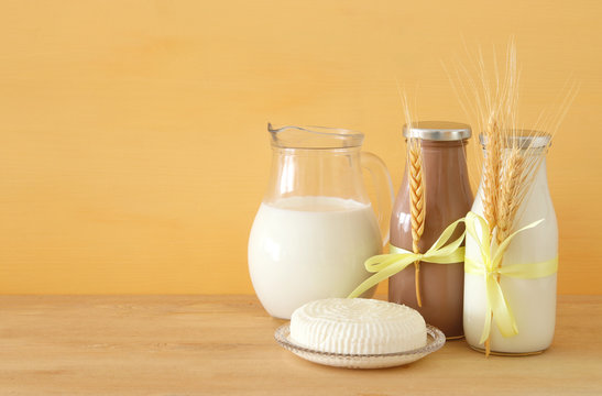 image of dairy products over wooden background. Symbols of jewish holiday - Shavuot.