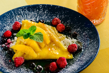 Sweet delicious pancake blinis with curd, jam and berries. New restaurant menu for the holiday...