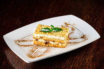 Sweet cheesecake dessert with mint in a plate