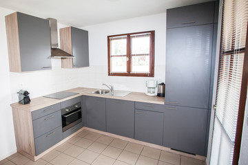 Fototapeta na wymiar Modern grey clean kitchen interior