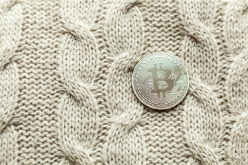 bitcoin coin on a wool background