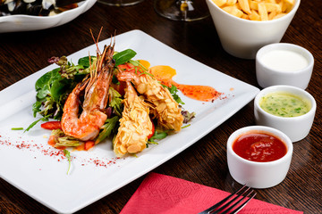 Delicious prepared shrimp with tomatoes, sauce and basil leaves at a restaurant