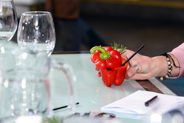 the man in the bar drinks a special bell-pepper cocktail in bell-pepper with rosemary