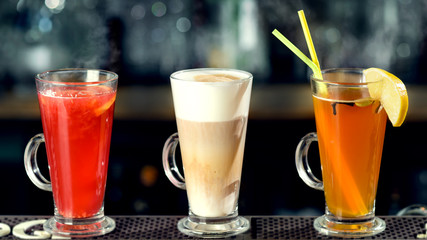 Latte and hot alcoholic cocktails at the bar counter. Cinema effect