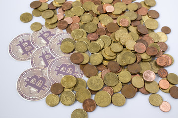 Cryptocurrency bitcoins and euro coins in a white background
