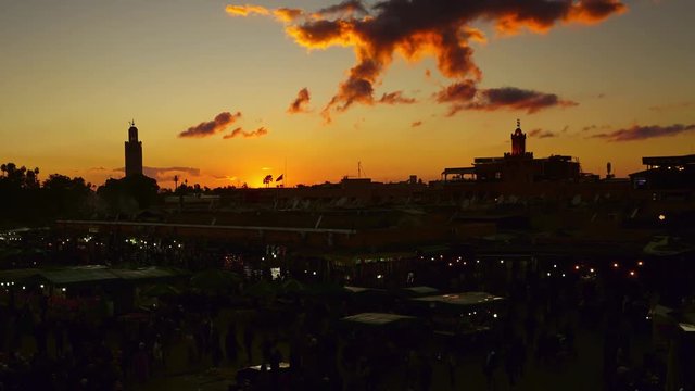Famous Jemaa el Fna square crowded at sunset, Marrakesh, Morocco, timelapse 4k