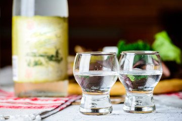 Two glasses with vodka at a restaurant, selective focus