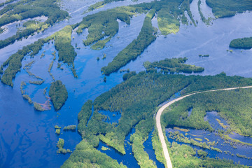 Country road in flooded forest plain