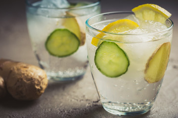 Sassy detox water with lemons, cucumbers and ginger. Healthy breakfast.
