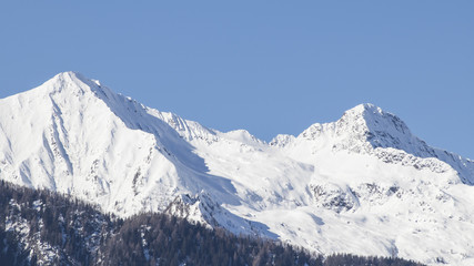European alps full of snow in a blue sky