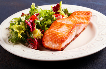 Fried salmon fillet and salad